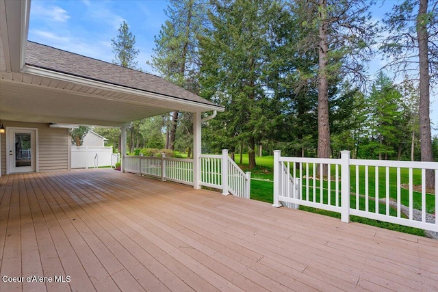 deck featuring view of wooded area