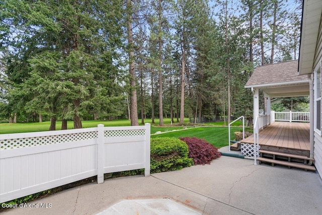view of patio / terrace featuring a deck and view of wooded area