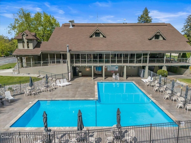 community pool featuring fence and a patio area