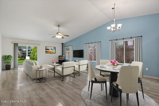 32350 N 7th Ave, Spirit Lake, ID 83869 - dining space with light wood-style floors, a chandelier, ceiling fan, high vaulted ceiling, and baseboards