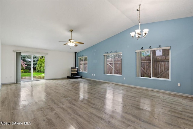 32350 N 7th Ave, Spirit Lake, ID 83869 - unfurnished living room with a wood stove, a chandelier, wood finished floors, baseboards, and high vaulted ceiling