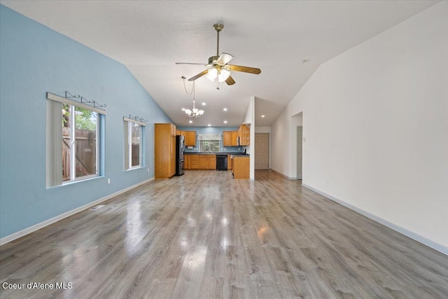 32350 N 7th Ave, Spirit Lake, ID 83869 - unfurnished living room featuring ceiling fan, baseboards, light wood-style floors, a chandelier, and high vaulted ceiling