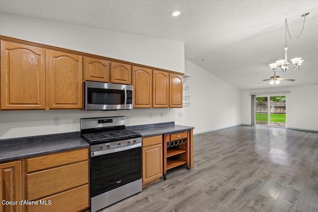 32350 N 7th Ave, Spirit Lake, ID 83869 - kitchen featuring stainless steel appliances, vaulted ceiling, dark countertops, a chandelier, and open floor plan