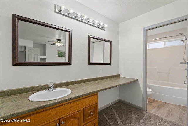 32350 N 7th Ave, Spirit Lake, ID 83869 - full bath with vanity, toilet, washtub / shower combination, a ceiling fan, and wood finished floors