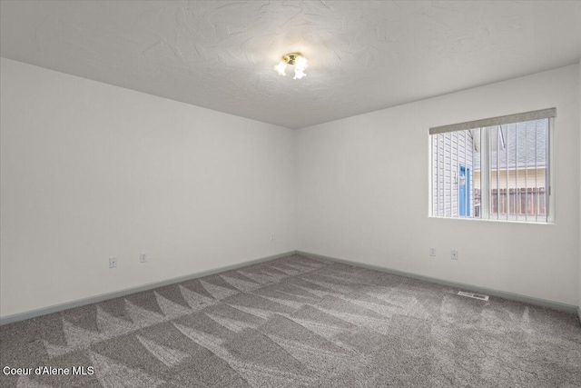 32350 N 7th Ave, Spirit Lake, ID 83869 - empty room featuring carpet floors, baseboards, and a textured ceiling