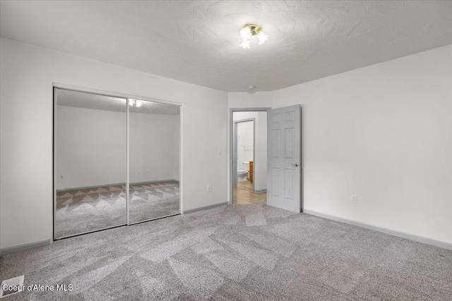 32350 N 7th Ave, Spirit Lake, ID 83869 - unfurnished bedroom with carpet flooring, a closet, and baseboards
