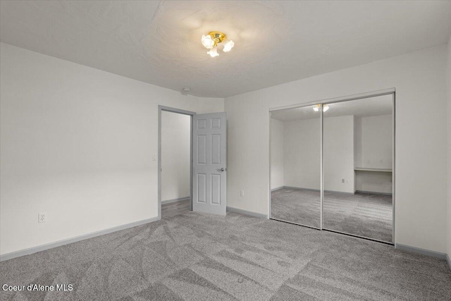 32350 N 7th Ave, Spirit Lake, ID 83869 - unfurnished bedroom with carpet floors, baseboards, and a closet
