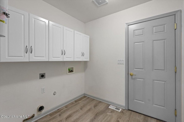 32350 N 7th Ave, Spirit Lake, ID 83869 - washroom with cabinet space, hookup for an electric dryer, hookup for a washing machine, light wood finished floors, and baseboards