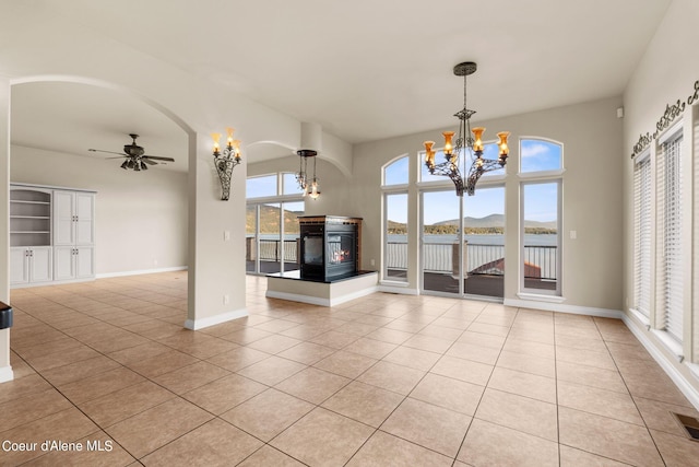 1100 S Division Ave, Sandpoint, ID 83864 - unfurnished dining area featuring baseboards, ceiling fan with notable chandelier, and light tile patterned floors