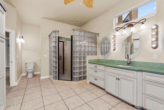 1100 S Division Ave, Sandpoint, ID 83864 - bathroom featuring vanity, tile patterned flooring, a shower stall, and toilet
