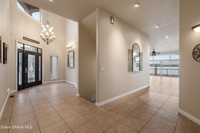 1100 S Division Ave, Sandpoint, ID 83864 - foyer with recessed lighting, baseboards, light tile patterned floors, and ceiling fan with notable chandelier