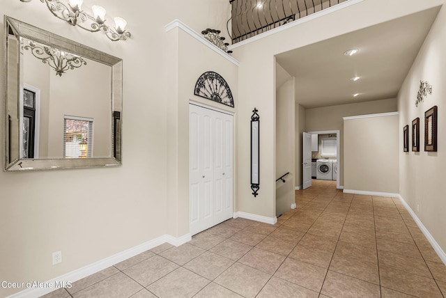 1100 S Division Ave, Sandpoint, ID 83864 - entrance foyer featuring baseboards, light tile patterned flooring, an inviting chandelier, and washer / dryer