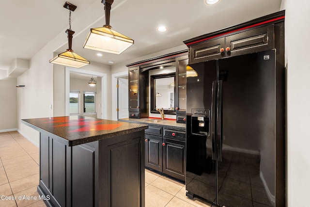 1100 S Division Ave, Sandpoint, ID 83864 - kitchen with a sink, black refrigerator with ice dispenser, light tile patterned floors, a kitchen island, and hanging light fixtures