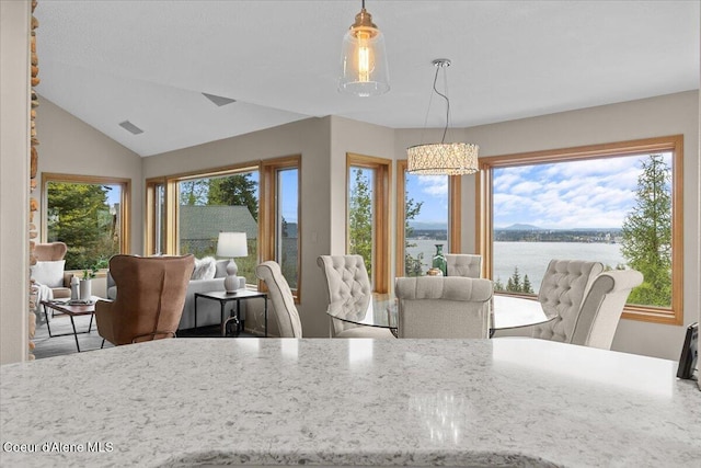 3677 S Capeview Ct, Coeur Dalene, ID 83814 - dining area with a water view, visible vents, a chandelier, and lofted ceiling