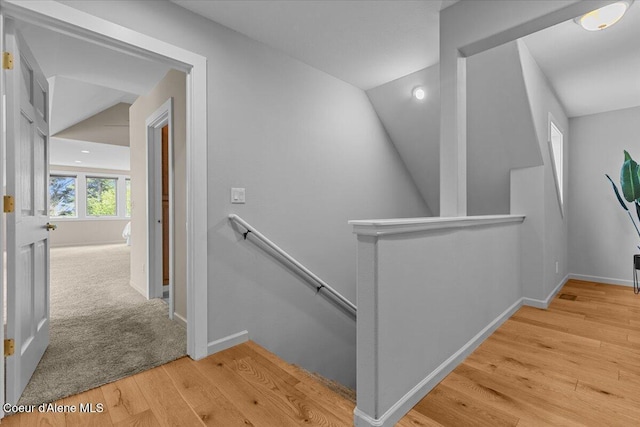 3677 S Capeview Ct, Coeur Dalene, ID 83814 - hall with baseboards, wood finished floors, and an upstairs landing