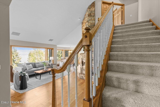 3677 S Capeview Ct, Coeur Dalene, ID 83814 - stairs with high vaulted ceiling and hardwood / wood-style flooring