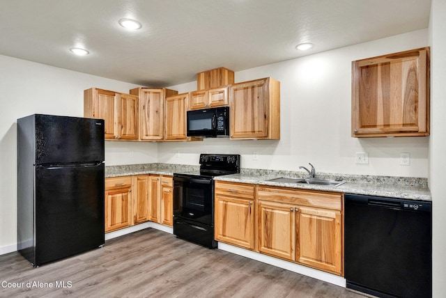 1119 Elm Dr, Saint Maries, ID 83861 - kitchen featuring black appliances, light wood finished floors, a sink, and recessed lighting