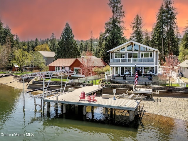 6339 W Harbor Dr, Coeur Dalene, ID 83814 - dock area featuring boat lift, fence, a water view, a balcony, and view of scattered trees