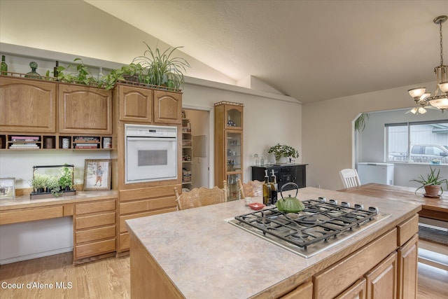3310 N 17th St, Coeur Dalene, ID 83815 - kitchen with oven, vaulted ceiling, stainless steel gas cooktop, light countertops, and light wood-style floors