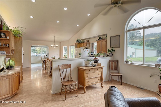 3310 N 17th St, Coeur Dalene, ID 83815 - kitchen with white refrigerator with ice dispenser, a chandelier, recessed lighting, light wood-type flooring, and a peninsula