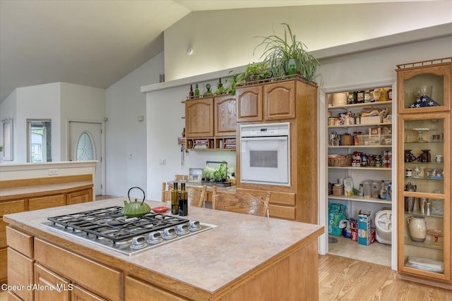 3310 N 17th St, Coeur Dalene, ID 83815 - kitchen with oven, stainless steel gas cooktop, light wood-style flooring, lofted ceiling, and light countertops
