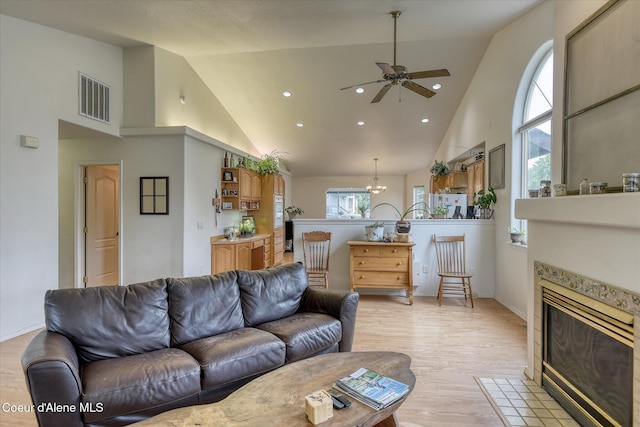 3310 N 17th St, Coeur Dalene, ID 83815 - living room with high vaulted ceiling, light wood-style floors, a fireplace, plenty of natural light, and a ceiling fan