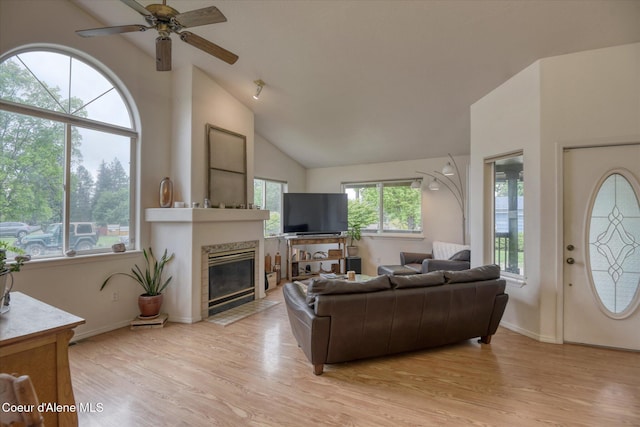 3310 N 17th St, Coeur Dalene, ID 83815 - living area with light wood finished floors, ceiling fan, a fireplace, vaulted ceiling, and baseboards