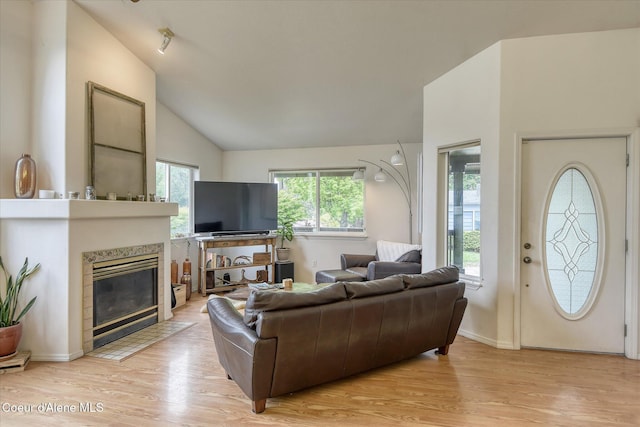 3310 N 17th St, Coeur Dalene, ID 83815 - living area with light wood-type flooring, a fireplace, lofted ceiling, and baseboards