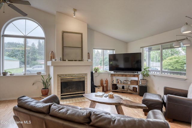 3310 N 17th St, Coeur Dalene, ID 83815 - living room with lofted ceiling, plenty of natural light, a tile fireplace, wood finished floors, and ceiling fan