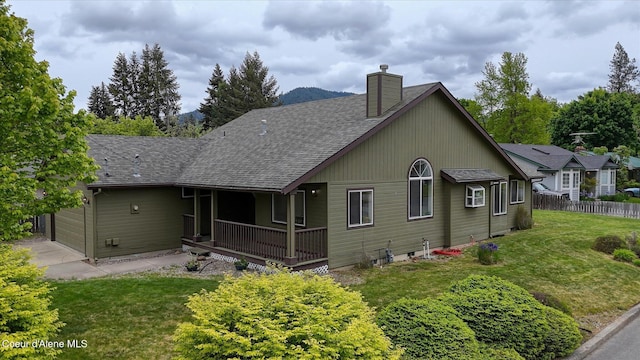 3310 N 17th St, Coeur Dalene, ID 83815 - back of property with roof with shingles, a chimney, a porch, driveway, and an attached garage