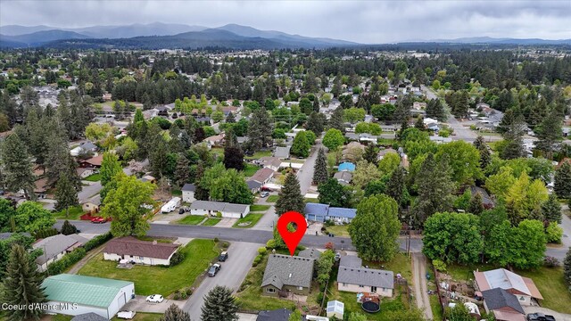 3310 N 17th St, Coeur Dalene, ID 83815 - aerial view of property and surrounding area with a mountain backdrop and nearby suburban area