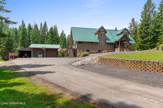 14105 E Marie Creek Rd, Coeur Dalene, ID 83814 - view of front of home featuring a front yard, metal roof, an outdoor structure, stairs, and aphalt driveway