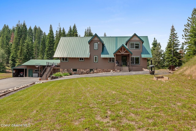 14105 E Marie Creek Rd, Coeur Dalene, ID 83814 - rustic home with a front lawn, metal roof, stairs, a carport, and aphalt driveway
