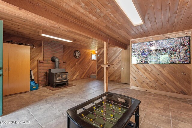 14105 E Marie Creek Rd, Coeur Dalene, ID 83814 - bonus room featuring tile patterned floors, wooden walls, a wood stove, and wooden ceiling