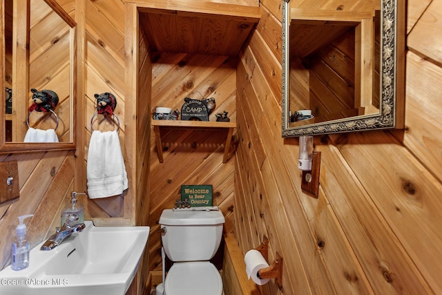14105 E Marie Creek Rd, Coeur Dalene, ID 83814 - bathroom featuring wood walls, toilet, and a sink