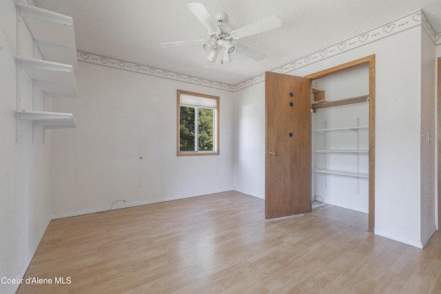 unfurnished bedroom featuring baseboards, wood finished floors, and ceiling fan
