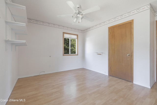 unfurnished room with ceiling fan, light wood-style flooring, and baseboards
