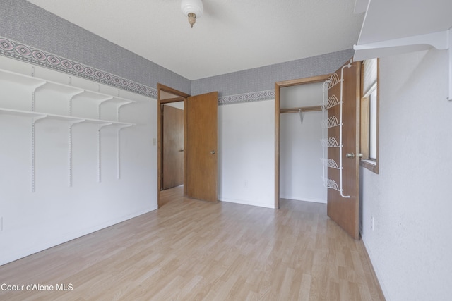unfurnished bedroom featuring wood finished floors and baseboards