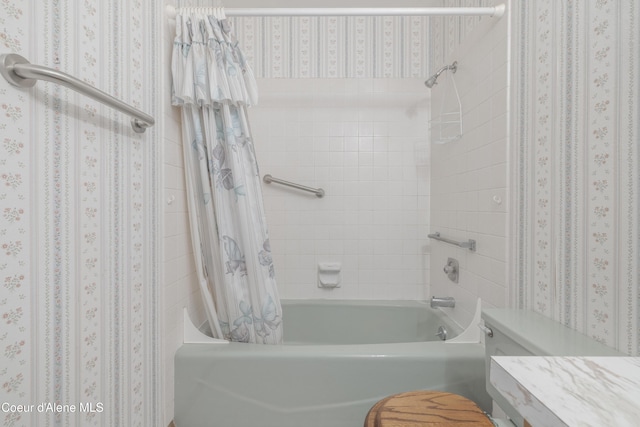 bathroom with shower / bath combination with curtain and wallpapered walls