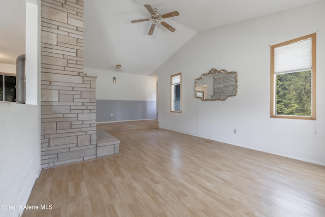 unfurnished living room with wood finished floors, a ceiling fan, and vaulted ceiling