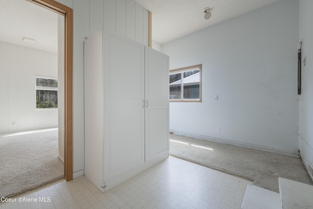 unfurnished room with light colored carpet and baseboards