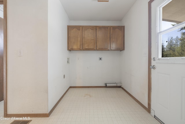 laundry area featuring light floors, electric dryer hookup, cabinet space, washer hookup, and baseboards