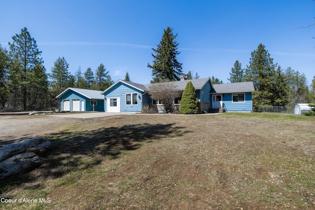 single story home with fence, a chimney, a front lawn, and a garage