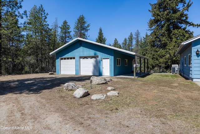 garage featuring a detached garage and central air condition unit