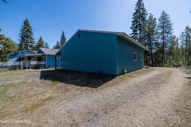 view of home's exterior with central AC unit and driveway