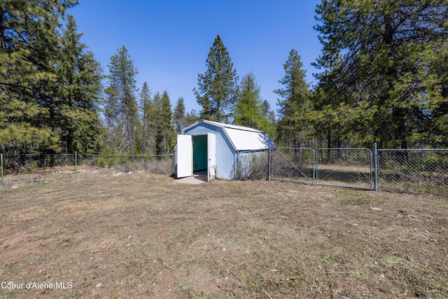 view of shed featuring a fenced backyard and a gate