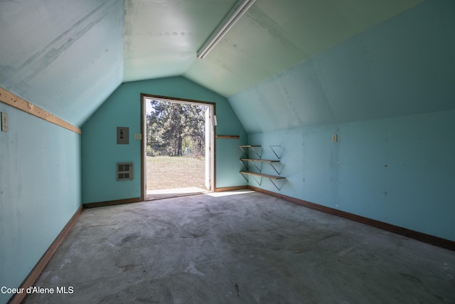 bonus room with baseboards, heating unit, and vaulted ceiling