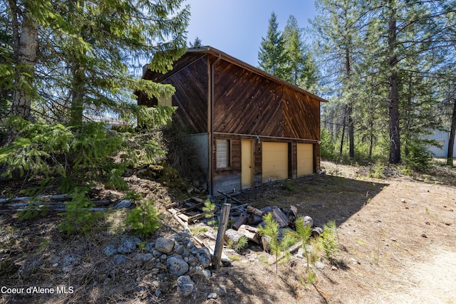 view of property exterior with an outdoor structure