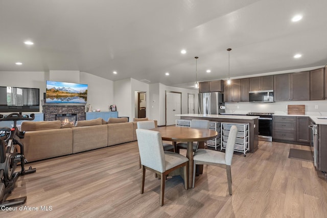 dining area with recessed lighting, light wood-style flooring, and vaulted ceiling