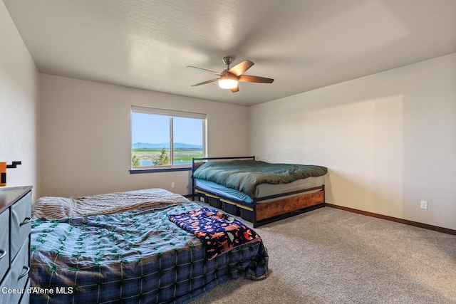 bedroom featuring carpet floors, a ceiling fan, and baseboards